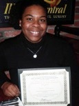 A young woman holding her certificate proudly